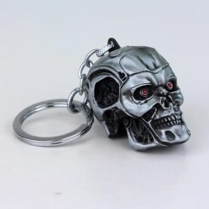 Caveira de metal do Exterminador do Futuro em grafite, com olhos vermelhos, como chaveiro