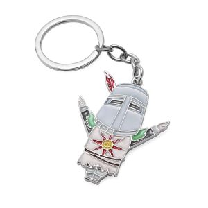 Solaire de Dark Souls em metal esmaltado, com braços abertos e sol no peito, preso a argola