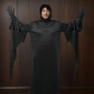 Homem de braços abertos com a túnica preta de capuz e mangas rasgadas do Ghostface