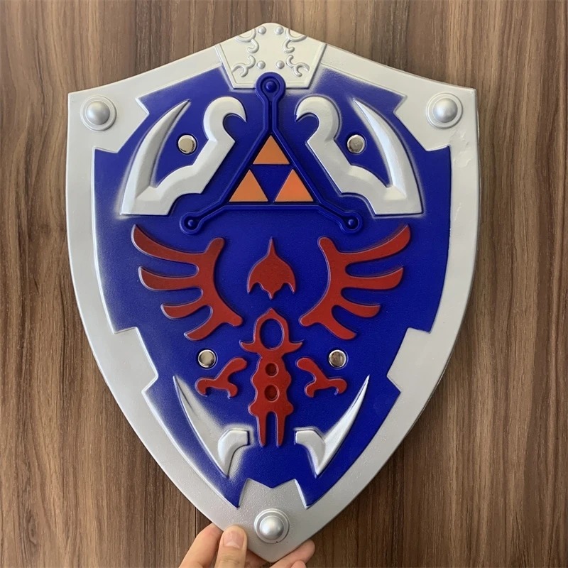 Escudo Hylian azul do Link com Triforce dourado e ave vermelha, visto de frente