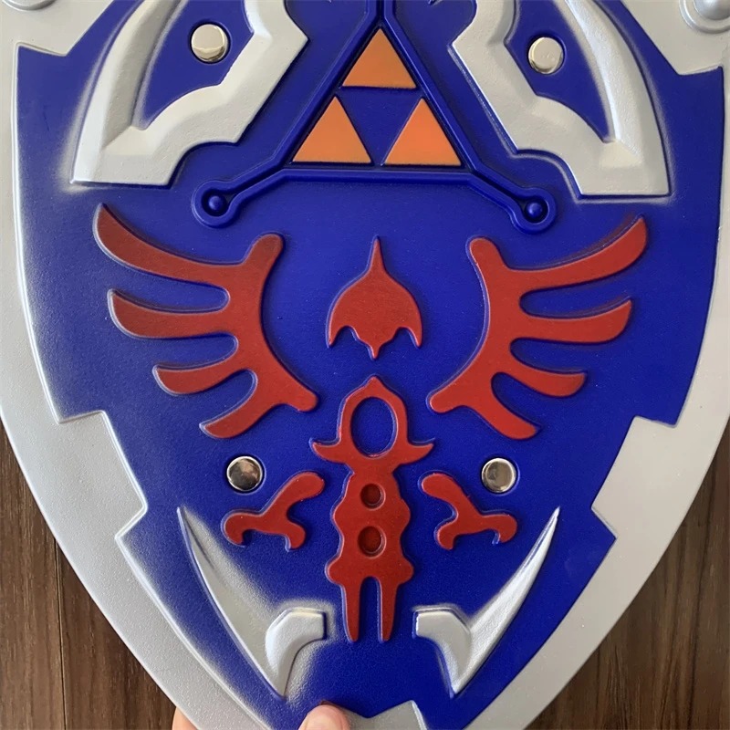 Close do Triforce e da ave vermelha no escudo do Link, de Zelda