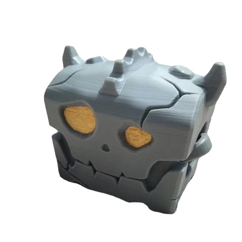 Estojo cinza em formato de baú monstro de Zelda, com rosto de caveira e olhos dourados