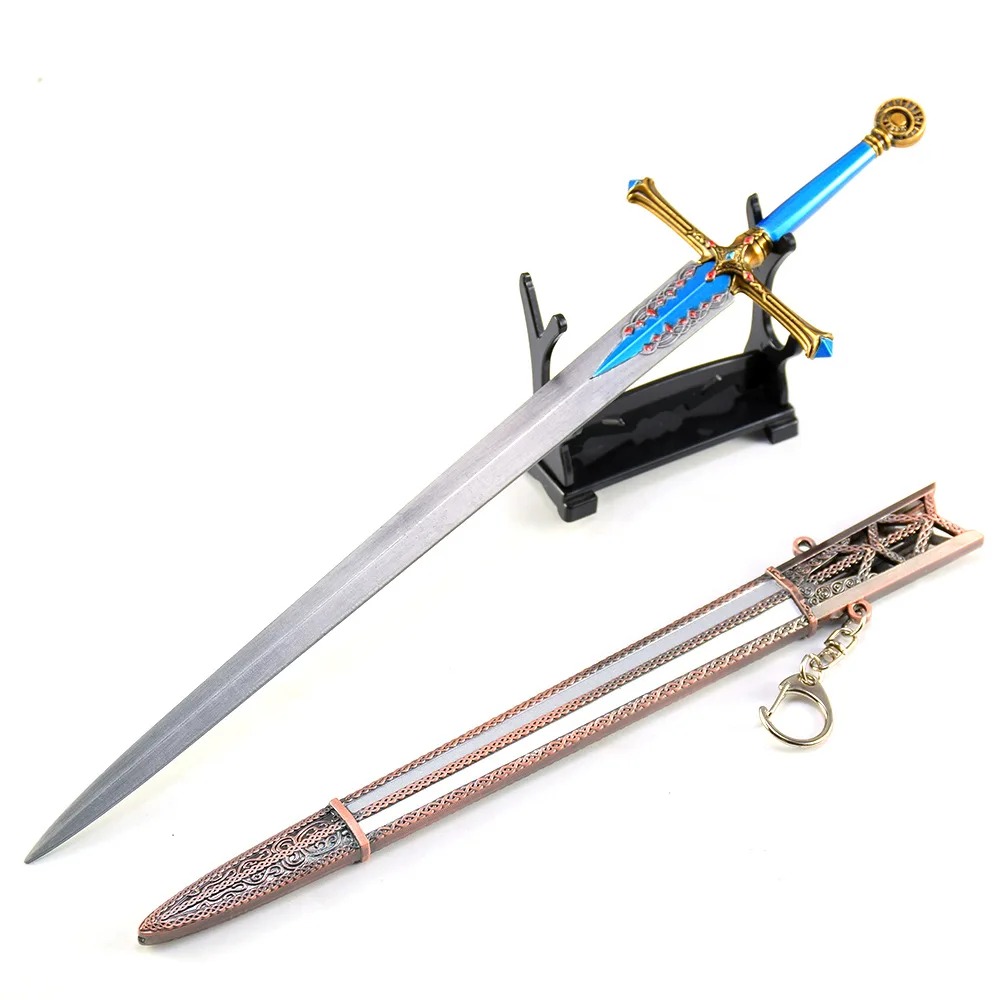 Miniatura da Carian Knight's Sword, de Elden Ring, com guarda dourada e detalhe azul, ao lado da bainha