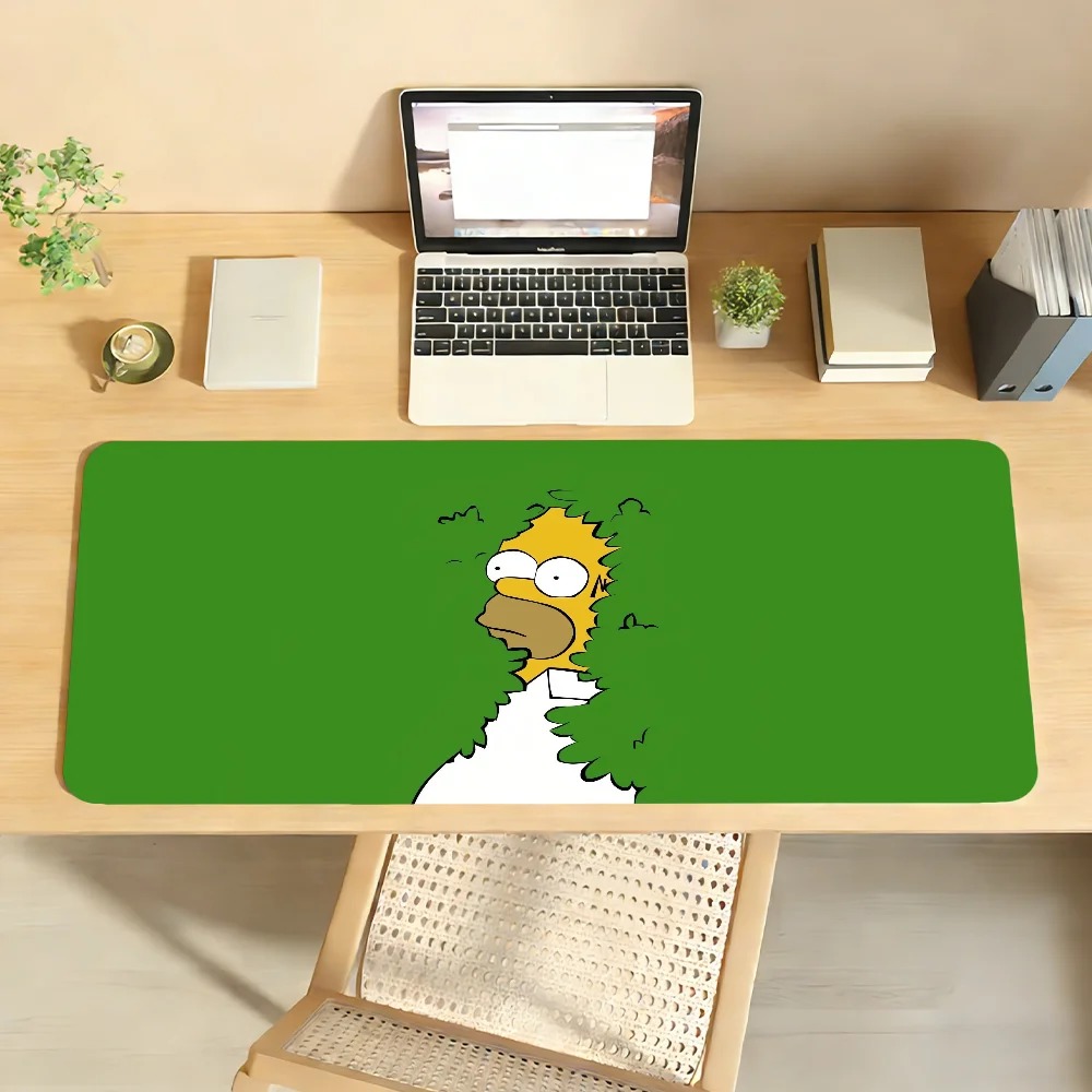 Mousepad verde com o Homer Simpson sumindo no arbusto, sobre uma mesa de escritório com notebook