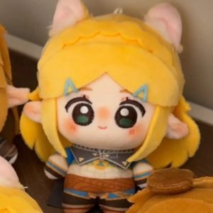 Pelúcia chibi da Princesa Zelda de cabeça grande, olhos verdes e cabelo loiro trançado