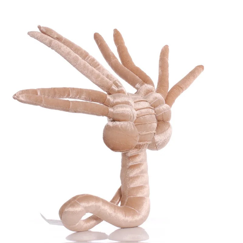 Pelúcia do facehugger de frente, patas abertas e cauda enrolada