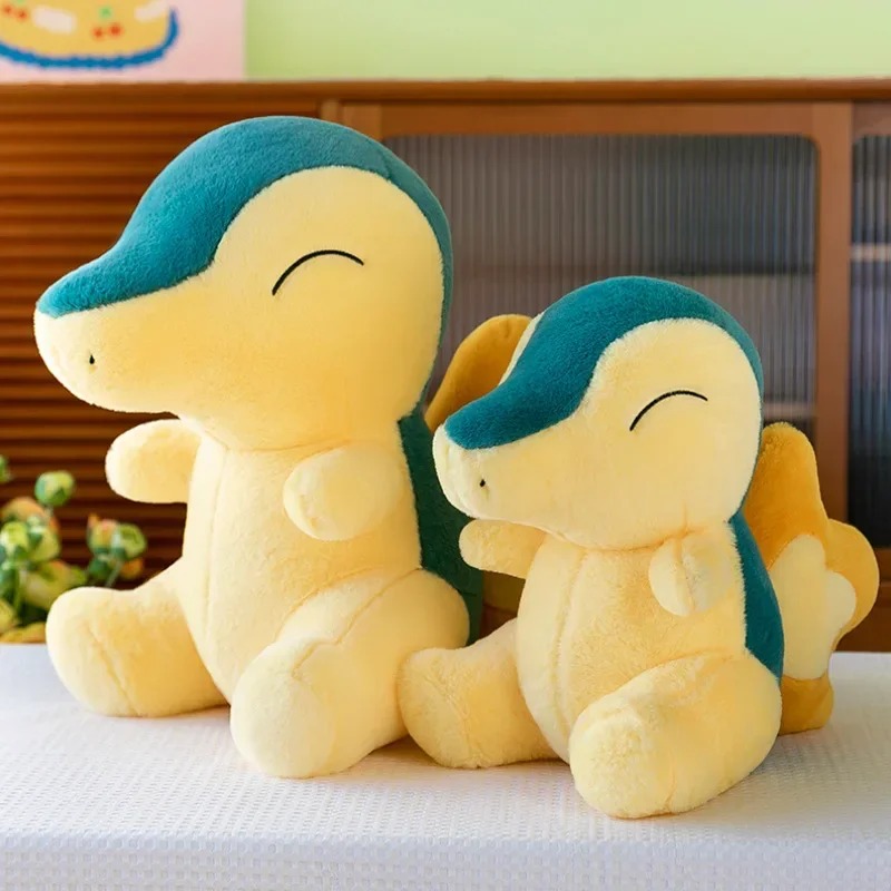 Duas pelúcias do Cyndaquil de tamanhos diferentes numa cama