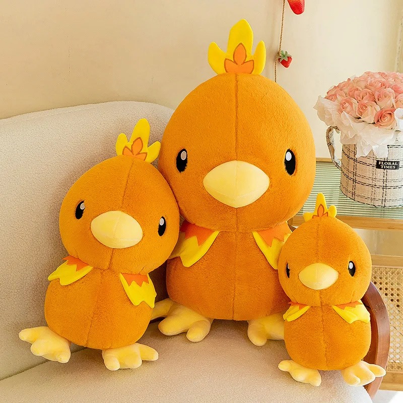 Três pelúcias do Torchic de tamanhos diferentes num sofá